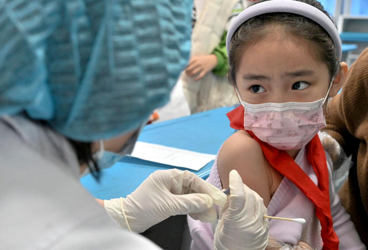 A child receives the COVID-19 coronavirus vaccine at a school in Handan, in China's northern Hebei province on Oct. 27, 2021. The city began vaccinating children between the ages of 3 to 11. (-/AFP via Getty Images)