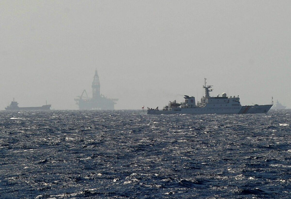 A Vietnamese coast guard ship shows a Chinese coast guard vessel (right) sailing near China's oil drilling rig in disputed waters in the South China Sea on May 14, 2014. (Hoang Dinh Nam/AFP via Getty Images)