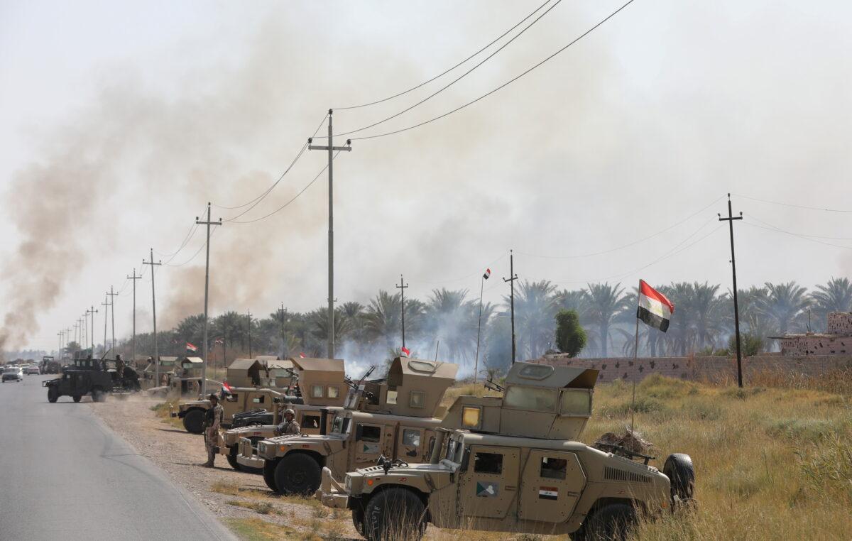 Military vehicles of Iraqi security forces are seen after an attack by ISIS terrorists near Muqdadiya, Iraq, on Oct. 27, 2021. (Stringer/Reuters)