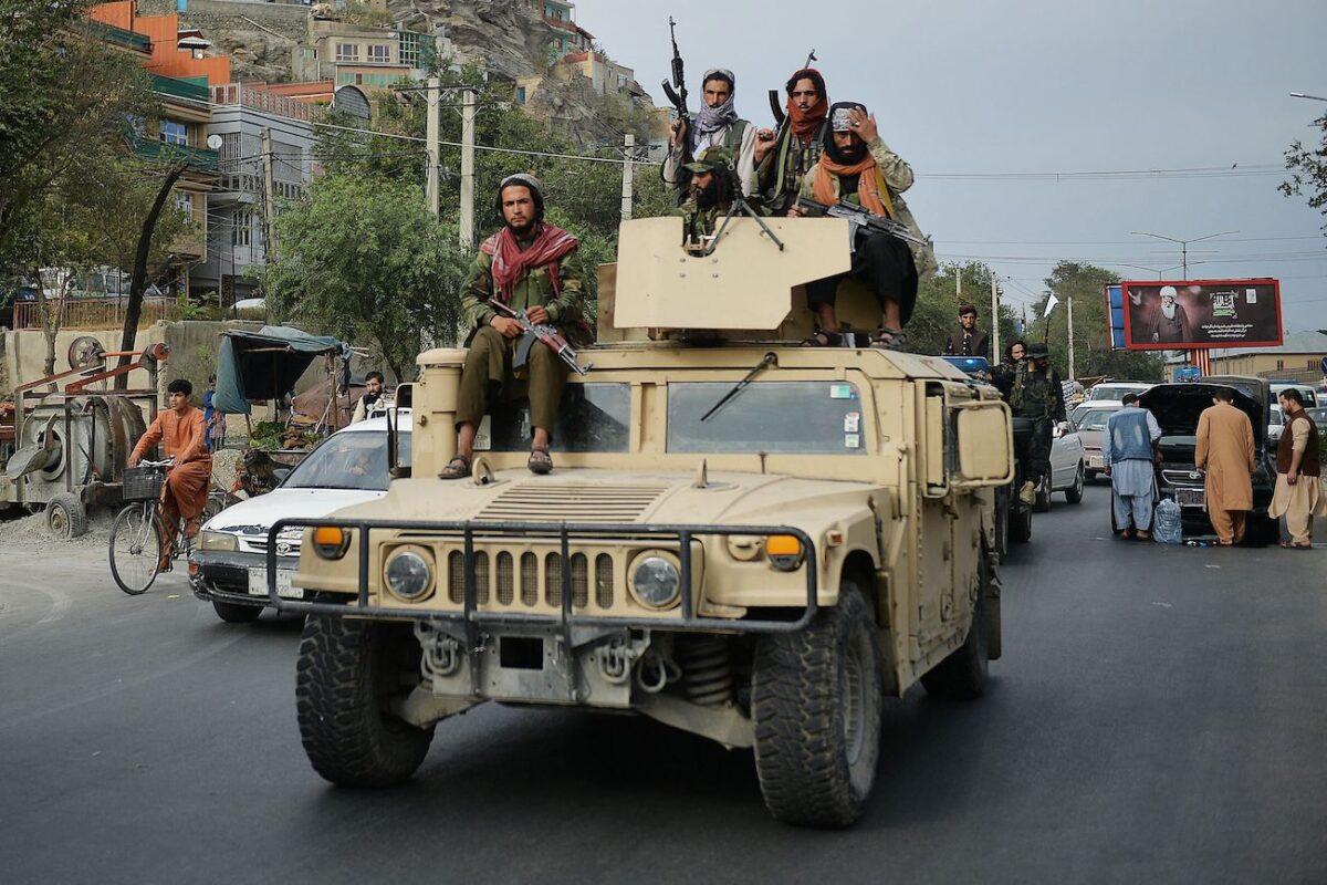 Taliban fighters atop a Humvee vehicle take part in a rally in Kabul, Afghanistan, on Aug. 31, 2021. (Hoshang Hashimi/AFP via Getty Images)