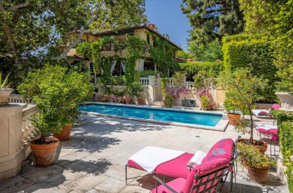 The stylish lap pool area is accented with climbing roses and is framed by a backdrop of eclectic landscaping elements. (Jim Bartsch/Jade Mills)
