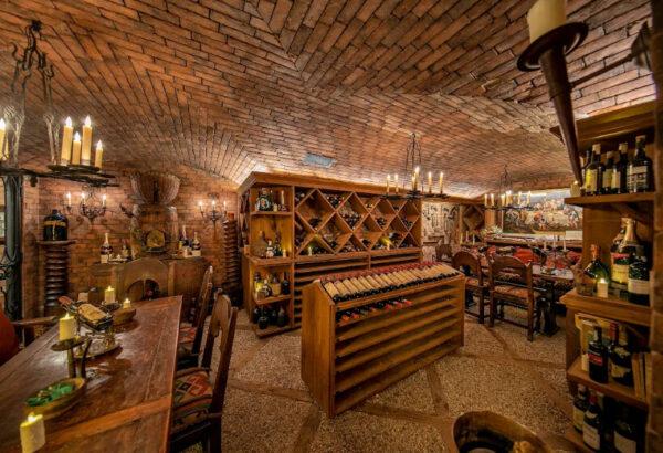 The mansion’s massive brick-lined wine cellar features a tasting corner and reflects the designer’s ideas of blending practical opulence with old-world charm. (Jim Bartsch/Jade Mills)