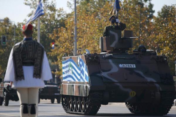 A tank with a Greek Flag painted on the side parades through the streets of the northern port city of Thessaloniki, Greece, during a military parade, on Oct. 28, 2021. (Giannis Papanikos/AP Photo)