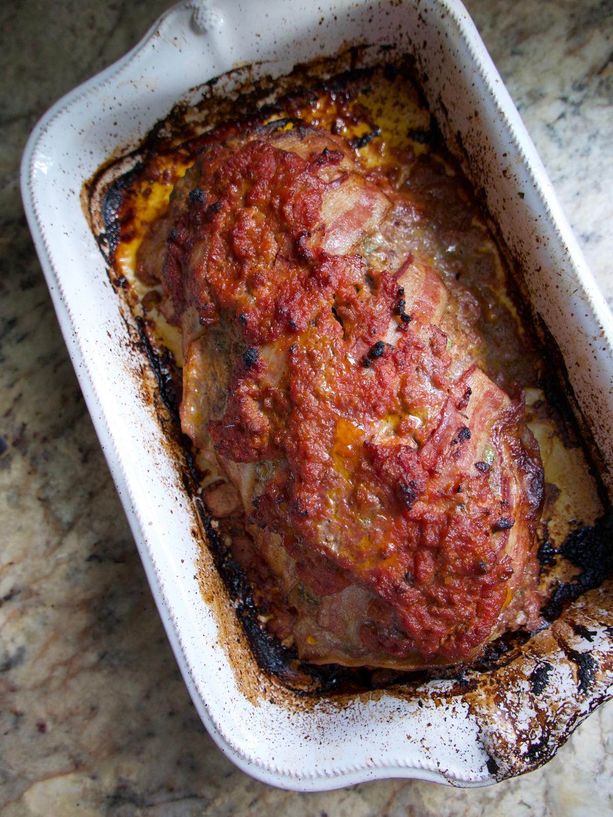 Wrapping this meatloaf in bacon and covering it in tomato sauce gives it a browned, crunchy crust. (Victoria de la Maza)