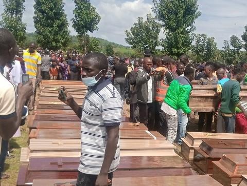 Caskets bearing the corpses of 38 Christian villagers killed in Madamai, Nigeria, by armed Fulani Muslim terrorists on Sept. 26, 2021, being arranged for a funeral mass at the Government Secondary School, Mallagun, about two miles from Madamai, on Sept. 30, 2021. (Luka Binniyat/The Epoch Times)