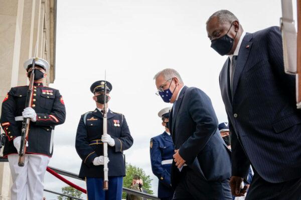 Australian Prime Minister Scott Morrison (L) and U.S. Secretary of Defense Lloyd Austin (R) walk past a military honor guard as they walk inside for a meeting at the Pentagon in Arlington, Va., on Sept. 22, 2021. (Drew Angerer/Getty Images)