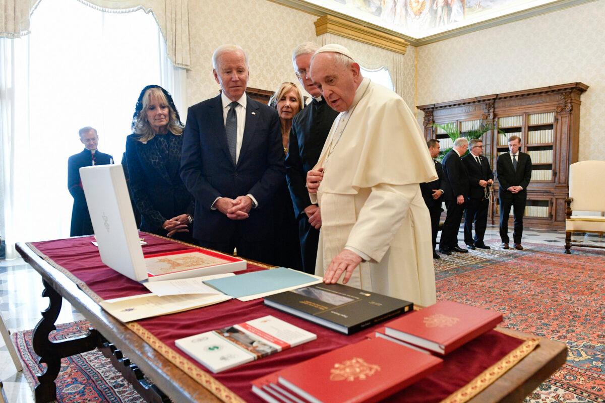 Pope Francis, right, speaks while showing items to U.S. President Joe Biden and First Lady Jill Biden, at the Vatican on Oct. 29, 2021. (The Epoch Times via White House)