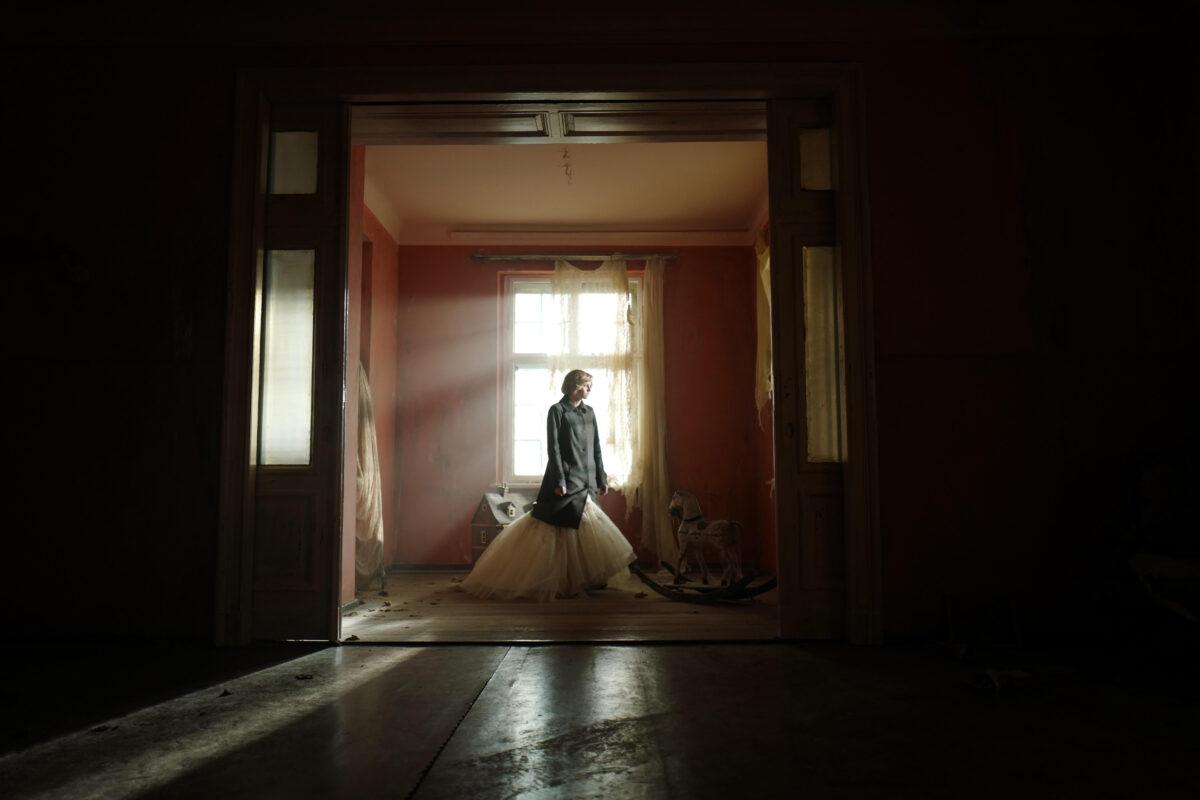 Princess Diana (Kristen Stewart) in her boarded-up and abandoned ancestral home, in “Spencer.” (Christina Zisa/Neon/Topic Studios)