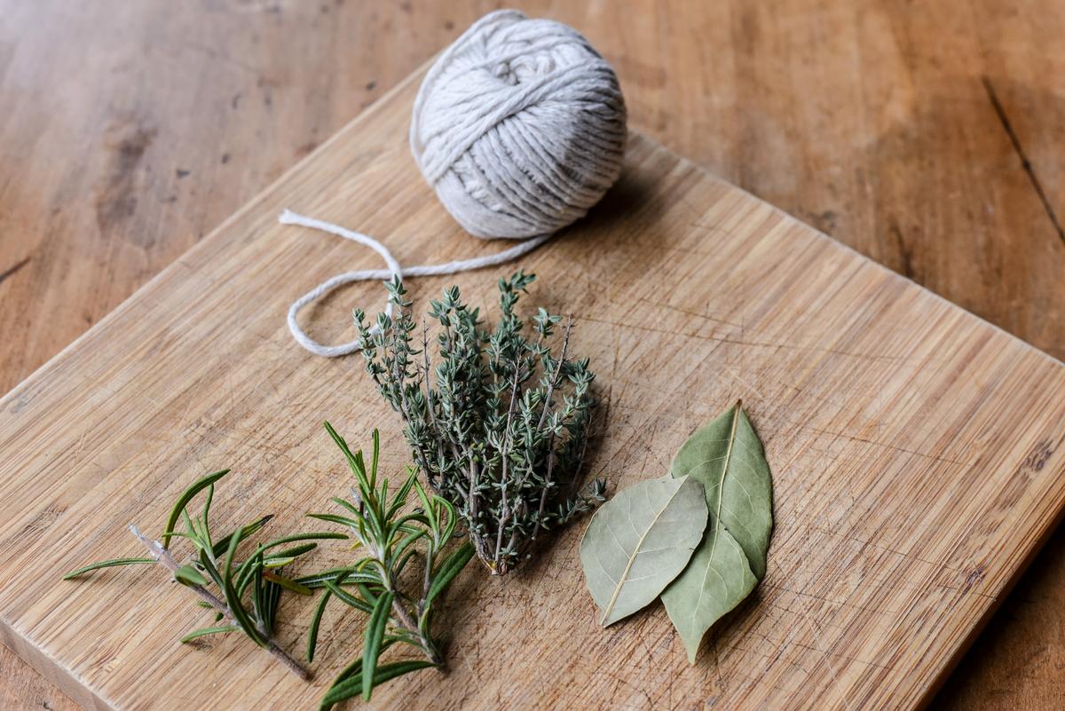 Tie together the rosemary, thyme, and bay leaves to make a bouquet garni. (Audrey Le Goff)
