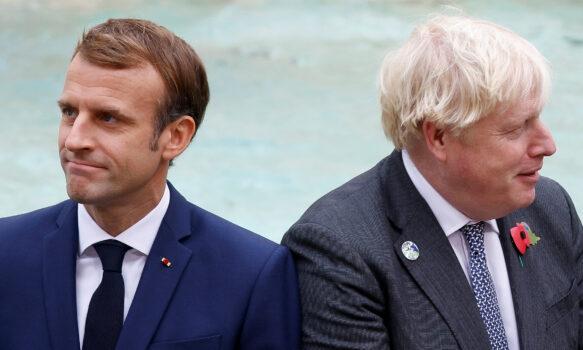 Britain’s Prime Minister Boris Johnson and French President Emmanuel Macron look on in front of the Trevi Fountain during the G20 summit in Rome, on Oct. 31, 2021. (Guglielmo Mangiapane/Reuters)