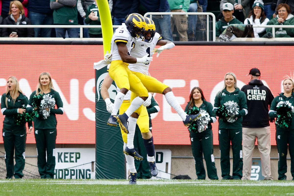 Michigan's Andrel Anthony (R), and A.J. Henning (3) celebrate Anthony's touchdown reception during the first quarter of an NCAA college football game against Michigan State in East Lansing, Mich., on Oct. 30, 2021. (Al Goldis/AP Photo)