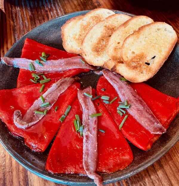 Piquillo peppers marinated with salt, pepper, and olive oil, topped with anchovy fillets and chives. (Joseph A. Lieberman)