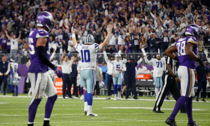 Dallas Cowboys quarterback Cooper Rush (10) celebrates after throwing a 5-yard touchdown pass to wide receiver Amari Cooper during the second half of an NFL football game against the Minnesota Vikings in Minn., on Oct. 31, 2021. (Bruce Kluckhohn/AP Photo)
