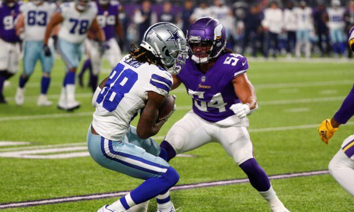Dallas Cowboys wide receiver CeeDee Lamb (88) catches a pass ahead of Minnesota Vikings middle linebacker Eric Kendricks (54) during the first half of an NFL football game in Minn., on Oct. 31, 2021. (Bruce Kluckhohn/AP Photo)