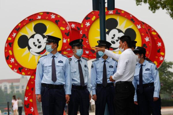 Security guards at Shanghai Disneyland after its reopening in Shanghai on May 11, 2020. (Hu Chengwei/Getty Images)