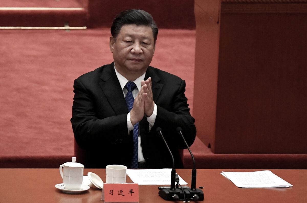 Chinese leader Xi Jinping applauds at the Great Hall of the People in Beijing, China, on Oct. 9, 2021. (Noel Celis/AFP via Getty Images)