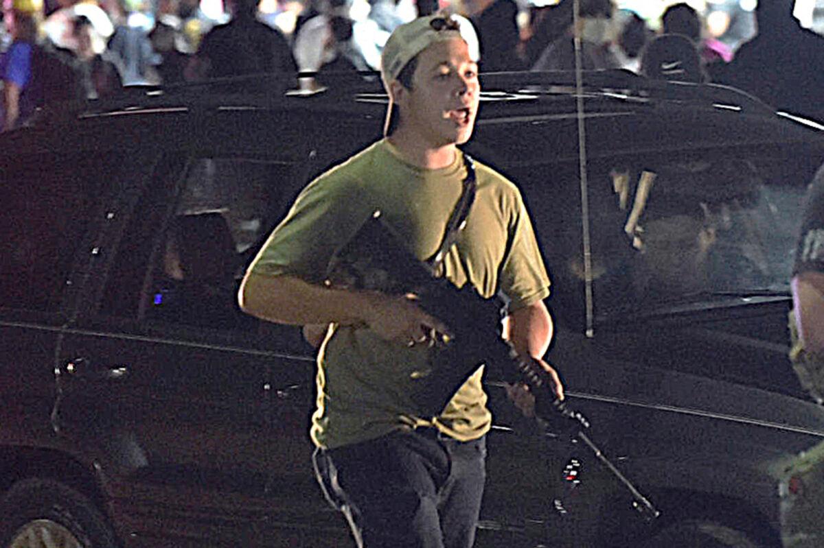Kyle Rittenhouse carries a weapon as he walks along Sheridan Road in Kenosha, Wis., on Aug. 25, 2020. (Adam Rogan/The Journal Times via AP)