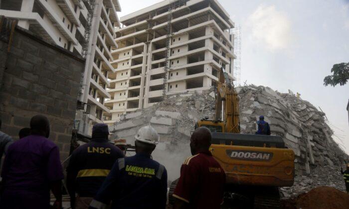 Rescue workers are seen at the site of a collapsed 21-story apartment building under construction in Lagos, Nigeria, on Nov. 1, 2021. (Sunday Alamba/AP Photo)