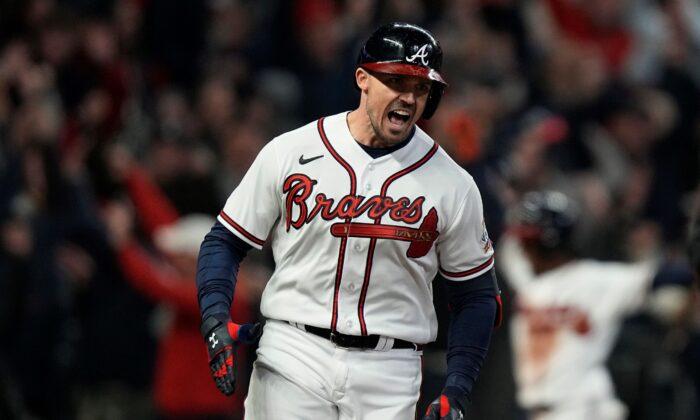 Atlanta Braves' Adam Duvall celebrates after his grand slam home run during the first inning in Game 5 of baseball's World Series between the Houston Astros and the Atlanta Braves in Atlanta, on Oct. 31, 2021. (Brynn Anderson/AP Photo)