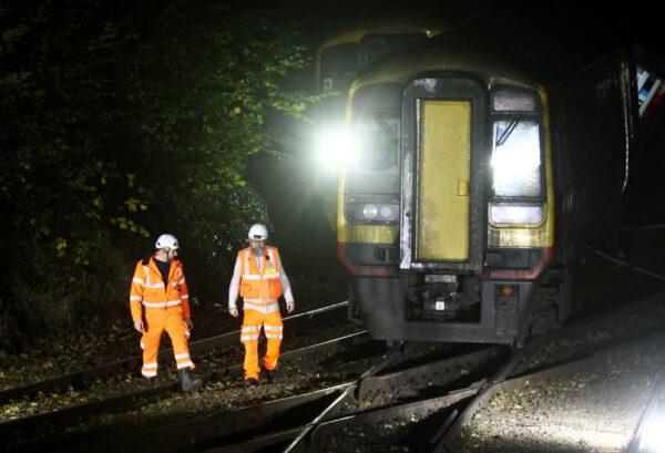 Emergency services personnel inspect the site where two trains crashed near Salisbury, Britain, on Oct. 31, 2021. (Henry Nicholls/Reuters)