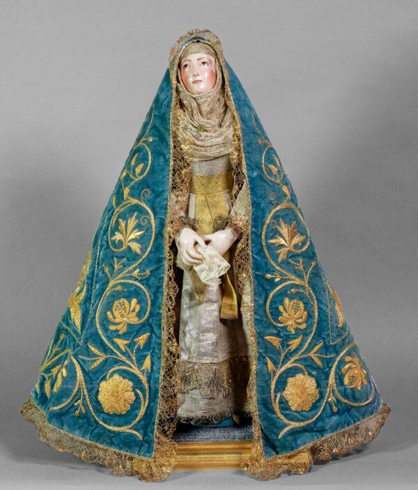 "Imagen de Vestir," circa 1800, by an anonymous sculptor. Polychromed wood armature with embroidered mantle including sequins, foil, and metal thread; 21 1/4 inches tall. (The Hispanic Society Museum & Library)