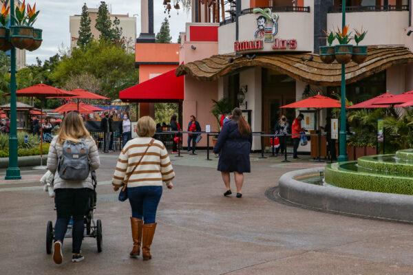 People walk through the Downtown Disney shopping and eating area in Anaheim, Calif., on Feb. 1, 2021. (John Fredricks/The Epoch Times)