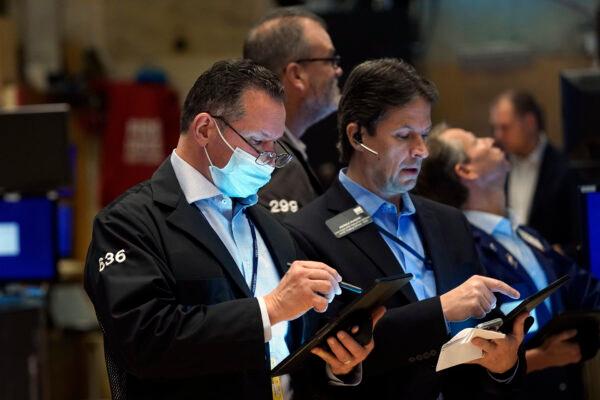 Edward Curran (L) works with fellow traders on the floor of the New York Stock Exchange on Nov. 2, 2021. (Richard Drew/AP Photo)