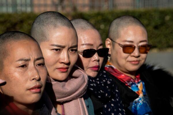 (L-R) Yuan Shanshan, Li Wenzu, Liu Ermin and Wang Qiaoling speak to the media after shaving their heads to protest the detention of their husbands, detained during the 709 Incident, in Beijing on Dec. 17, 2018. (Fred Dufour/AFP via Getty Images)