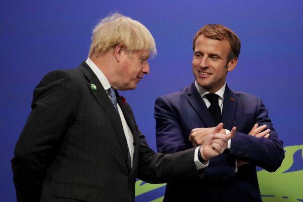 Britain's Prime Minister Boris Johnson greets French President Emmanuel Macron as he arrives to attend the COP26 UN Climate Change Conference in Glasgow, Scotland, on Nov. 1, 2021. (Christopher Furlong /pool/AFP via Getty Images)