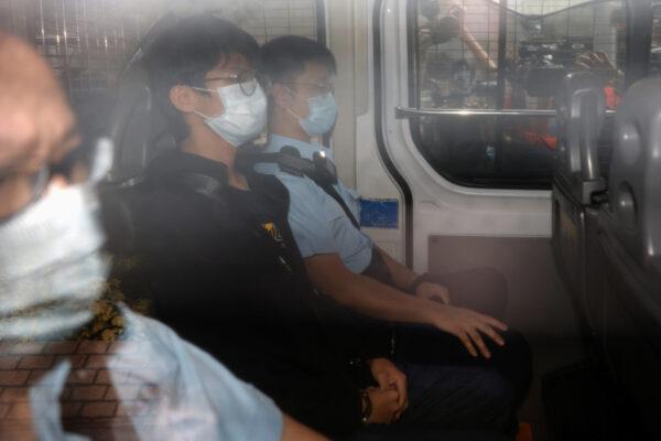 Former convenor of pro-independence group Studentlocalism Tony Chung arrives at West Kowloon Magistrates‘ Courts in a police van in Hong Kong on Oct. 15, 2020. (Tyrone Siu/Reuters)
