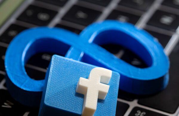 A 3D printed Facebook's new rebrand logo Meta and Facebook logo are placed on laptop keyboard in this illustration, taken on Nov. 2, 2021. (Dado Ruvic/Reuters)