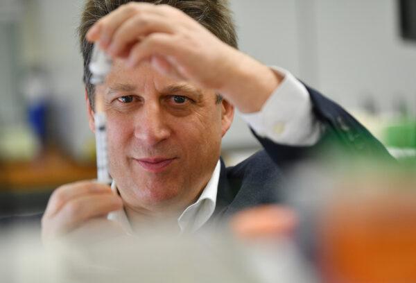 Vaxine research director Nikolai Petrovsky in the Flinders University lab in Adelaide, South Australia, with a vaccine specimen, on July 2, 2020. (AAP Image/David Mariuz)