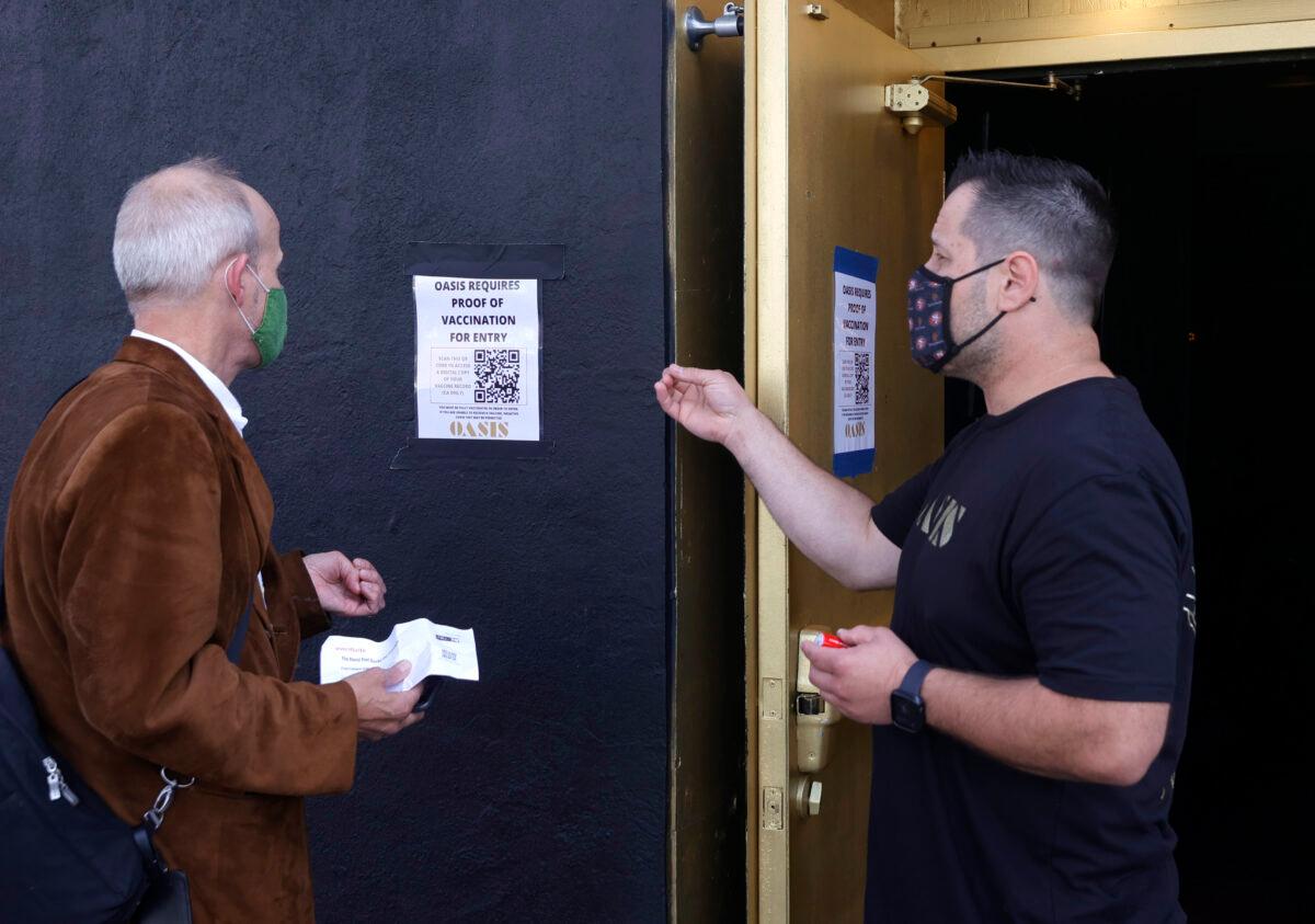 A doorman at Oasis informs a customer that a vaccination card is required to enter the club, in San Francisco, Calif., on July 29, 2021. (Justin Sullivan/Getty Images)
