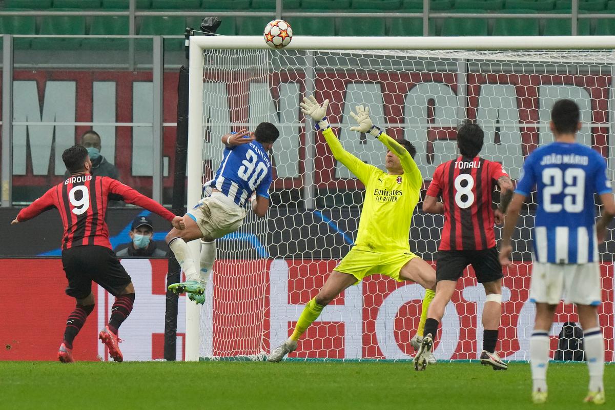 Porto's Evanilson (2nd L), heads the ball to hit the bar during the Champions League group B soccer match between AC Milan and Porto at the San Siro stadium in Milan, Italy, on Nov. 3, 2021. (Luca Bruno/AP Photo)