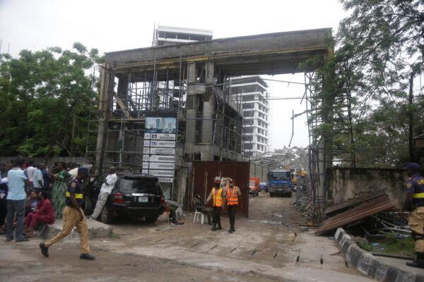 Rescue workers at the site of the acollapsed 21-story apartment building under construction in Lagos, Nigeria, on Nov. 2, 2021. (Sunday Alamba/AP Photo)