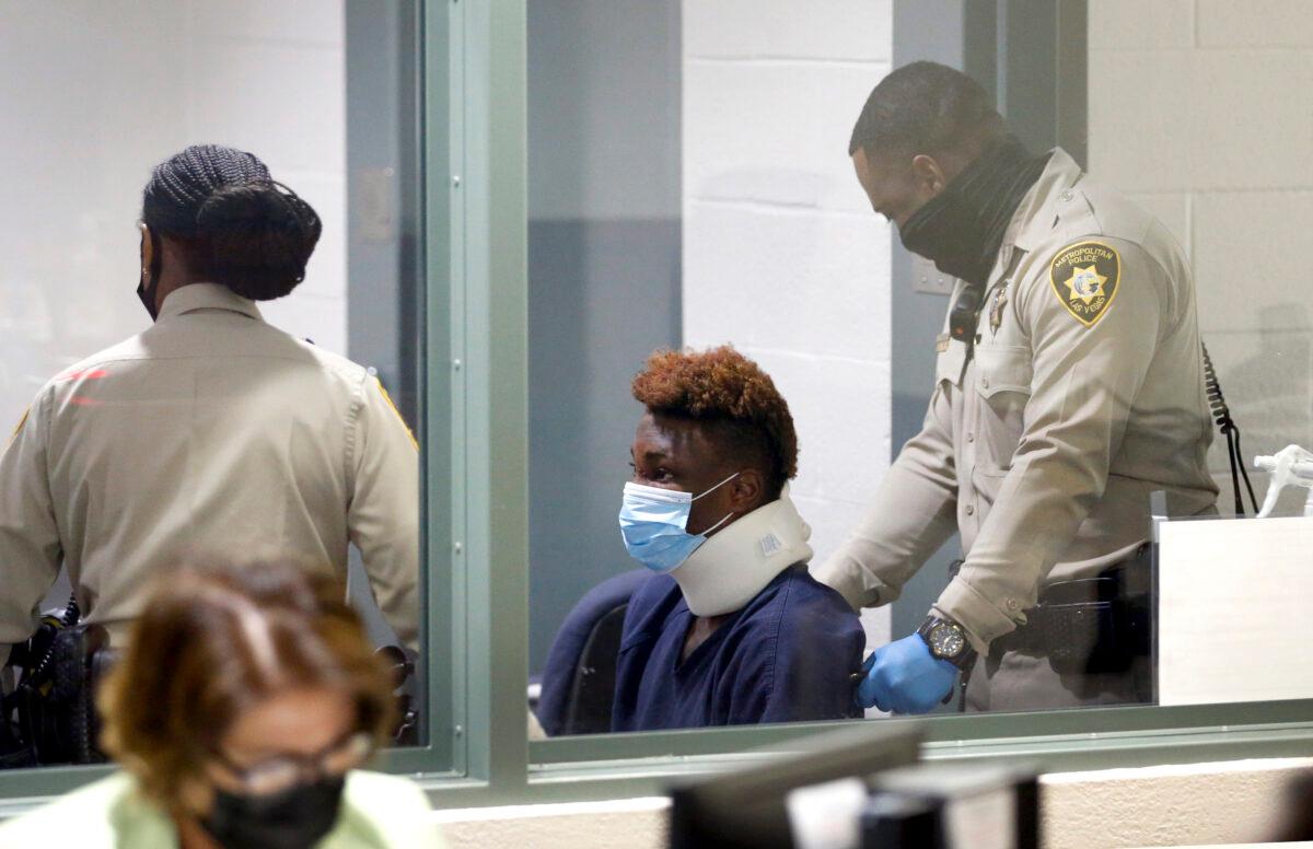 Las Vegas Raiders wide receiver Henry Ruggs III is taken out of the courtroom in a wheelchair after making an initial appearance in Las Vegas Justice Court in Las Vegas on Nov. 3, 2021. (Steve Marcus/Las Vegas Sun via AP)