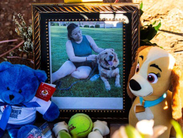 A photography of Tina Tintor, 23, and her dog is placed at a makeshift memorial site to honor them at South Rainbow Boulevard and Spring Valley Parkway in Las Vegas, Nev., on Nov. 4, 2021. (Bizuayehu Tesfaye/Las Vegas Review-Journal via AP)