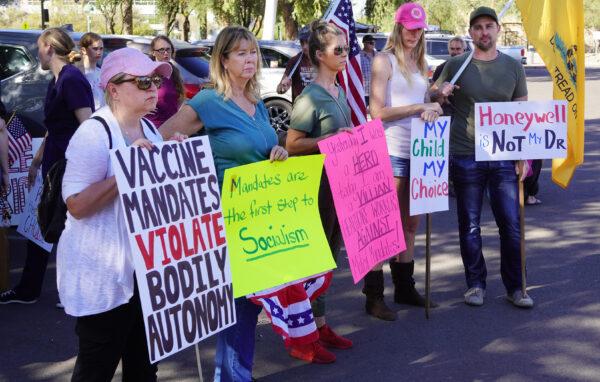  Protesters get their messages across at a rally in support of medical freedom in Phoenix on Nov. 3, 2021. (Allan Stein/Epoch Times)