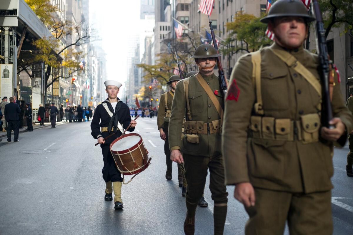 A drummer boy next to men dressed up as World War I U.S. Army soldiers march in the New York Veterans' Day Parade in Manhattan, N.Y., on Nov. 11, 2014. (Samira Bouaou/The Epoch Times)