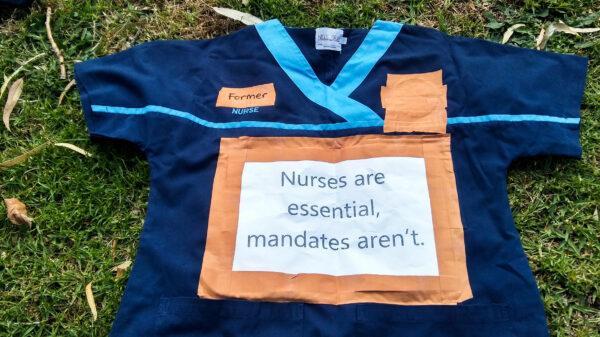 Health staff leave their uniforms in protest over Western Australia's vaccine mandates outside of Dumas House in Perth, Australia, on Nov. 1, 2021. (The Epoch Times)