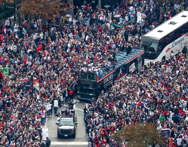 Fans cheer the 2021 World Series baseball champion Atlanta Braves during a victory parade in Atlanta, on Nov. 5, 2021. (Curtis Compton/Atlanta Journal-Constitution via AP)