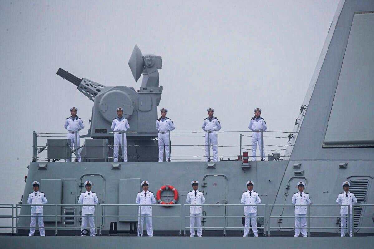 Sailors stand on the deck of the new type 055 guide missile destroyer Nanchang of the Chinese People's Liberation Army (PLA) Navy as it participates in a naval parade to commemorate the 70th anniversary of the founding of China's PLA Navy in the sea near Qingdao, in eastern China's Shandong Province on April 23, 2019. (Mark Schiefelbein/AFP via Getty Images)