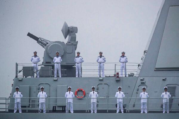 Sailors stand on the deck of the new type 055 guided-missile destroyer Nanchang of the Chinese People's Liberation Army (PLA) Navy as it participates in a naval parade to commemorate the 70th anniversary of the founding of China's PLA Navy in the sea near Qingdao, Shandong Province, China, on April 23, 2019. (Mark Schiefelbein/AFP via Getty Images)