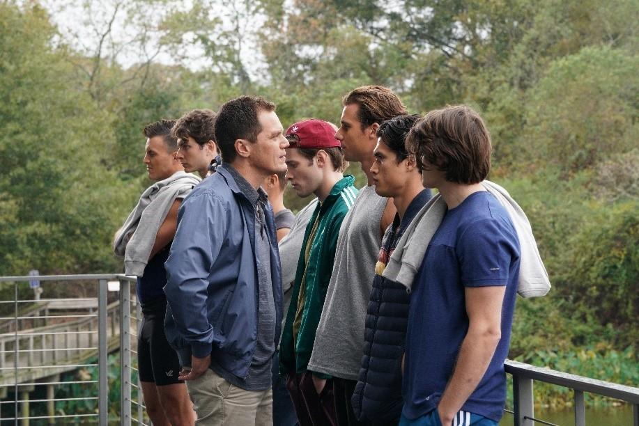 Coach Jack Murphy (Michael Shannon, blue jacket, left C) teaches his crew team life lessons, in “Heart of Champions.” (Vertical Entertainment)