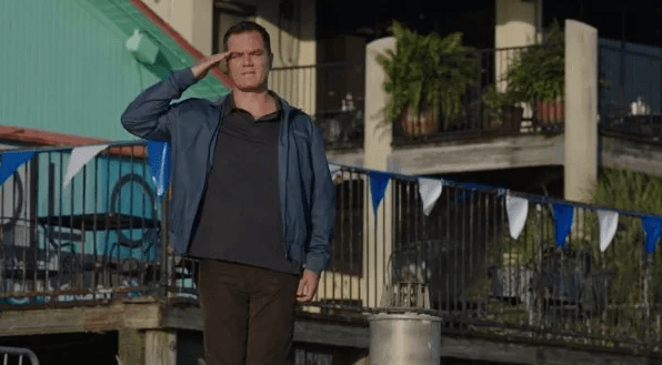 Coach Jack Murphy (Michael Shannon) salutes his team when they dig deep and overcome their inner obstacles, in “Heart of Champions.” (Vertical Entertainment)