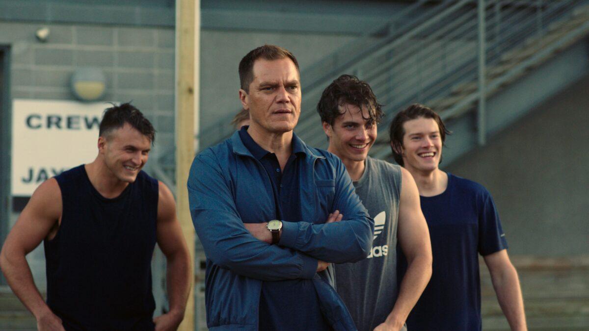 Army veteran and coach Jack Murphy (Michael Shannon, front C) has an arrogant team member try to row the boat by himself, in “Heart of Champions.” (Vertical Entertainment)