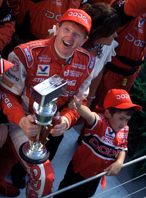 Chase Elliott (R), son of Brickyard 400 champion Bill Elliott, celebrates with his father after winning the ninth running of the Brickyard 400 at the Indianapolis Motor Speedway on Aug. 4, 2002. (Dave Parker/AP Photo)