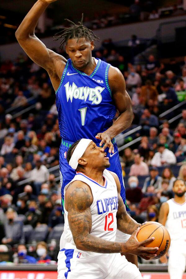 Minnesota Timberwolves forward Anthony Edwards (1) fouls Los Angeles Clippers guard Eric Bledsoe (12) during the first half of an NBA basketball game in Minneapolis, Minn., on Nov. 5, 2021. (Andy Clayton-King/AP Photo)