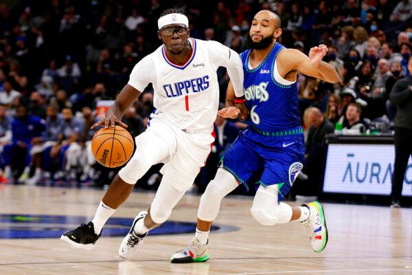 Los Angeles Clippers guard Reggie Jackson (1) drives on Minnesota Timberwolves guard Jordan McLaughlin (6) during the first half of an NBA basketball game in Minneapolis, Minn., on Nov. 5, 2021. (Andy Clayton-King/AP Photo)