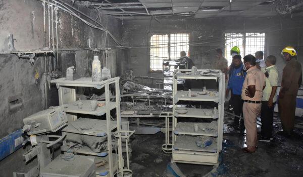 People inspect a hospital's COVID-19 ward that caught fire in Ahmednagar, in the western Indian state of Maharashtra on Nov. 6, 2021. (AP Photo)